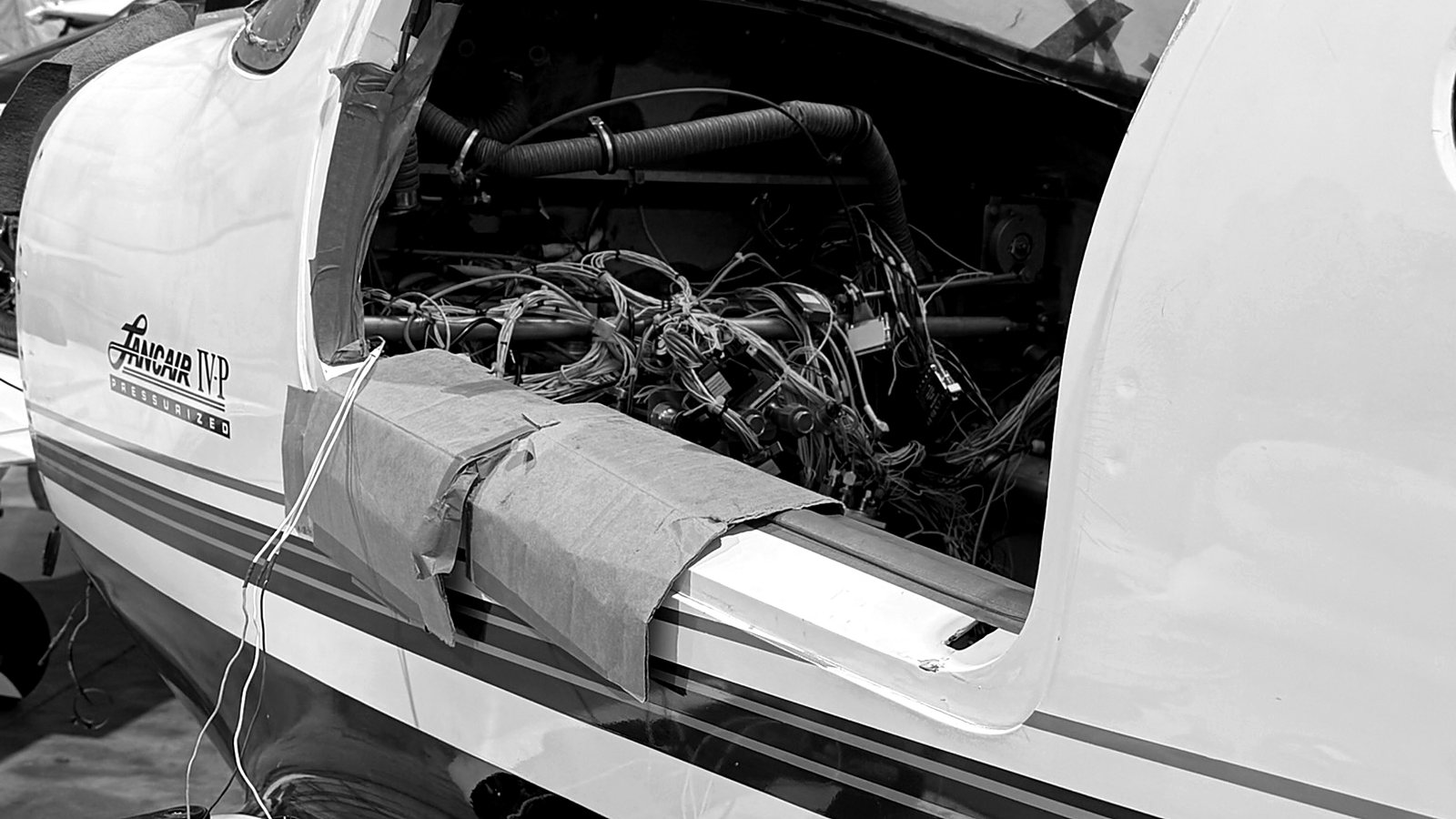Aircraft panel opened for an avionics retrofit, wire harness bundle exposed