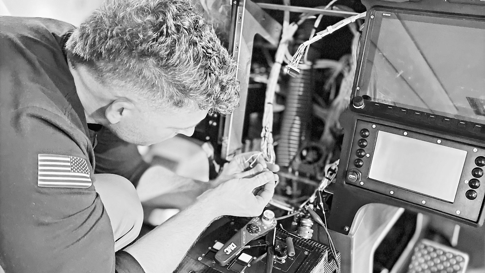 Aviation maintenance technician standing at a tool box on a hangar floor